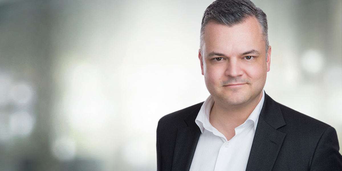 Man in jacket with open shirt collar has his Corporate Headshot made at Yungblut Photography Studio in Niagara