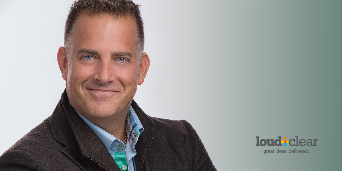 Advertising Executive has his Studio Headshot made by downtown St. Catharines photographer against a branded backdrop