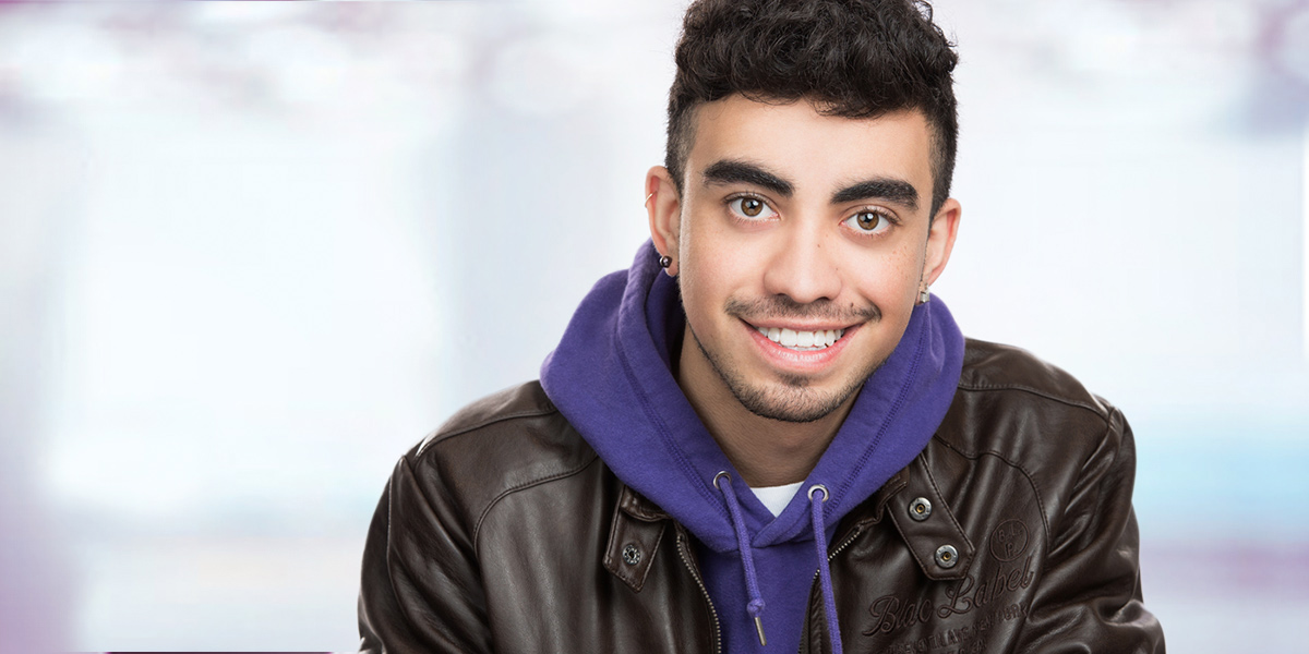 Cool looking headshot of Niagara student wearing leather jacket and purple hoodie, shot at Yungblut Photography in St. Catharines
