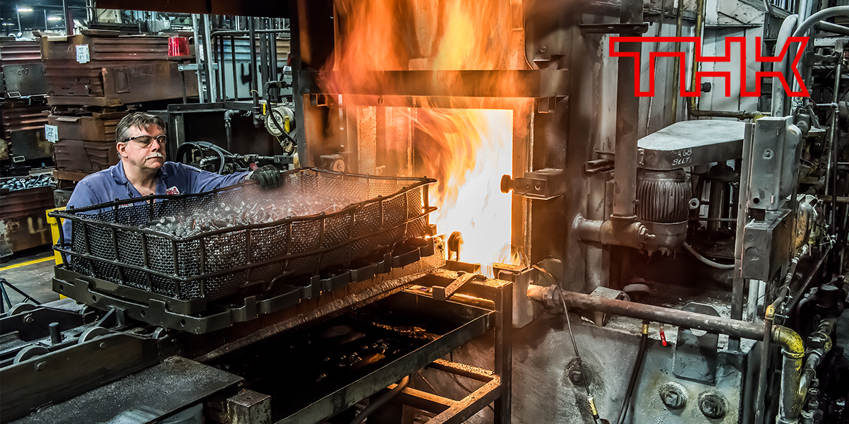 Industrial Image of a man working at a Factory behind a Metal Cage and Fire, shot by Yungblut for an Advertising Annual Report